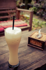 Iced coffee and Bamboo tissue box in the cafe garden