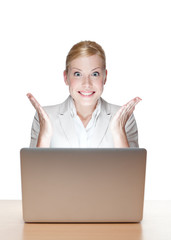 Happy attractive businesswoman sitting at a table with laptop