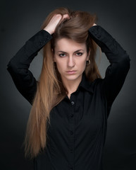 Young girl touches her hair hands