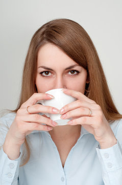 Girl with a cup of coffee drinkers
