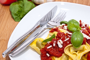 Fresh Tortellini on wooden background