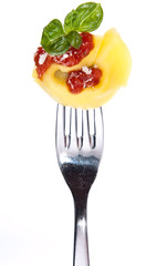 Tortellini on a fork isolated on white