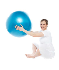Pregnant woman playing with exercise ball