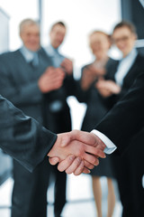 Succesful handshake with business people aplauding