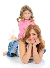 cheerful girl hugs her young mother.