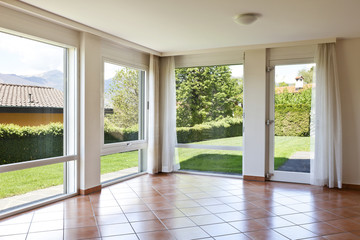 room with terracotta floor,.windows overlooking the garden