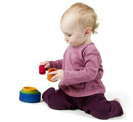 young child playing with colorful toy blocks
