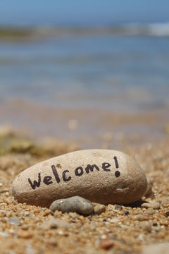 Welcome! - Written on a rock, at the beach