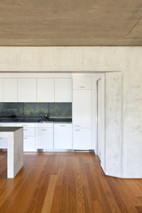 modern concrete house with hardwood floor, detail kitchen