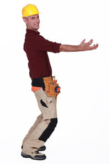 Tradesman carrying an invisible object
