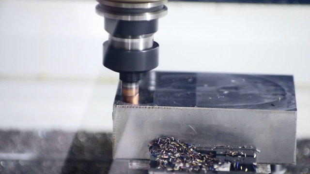 CNC machine milling some steel part