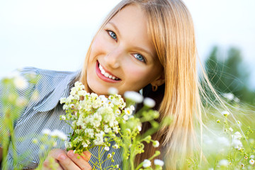 Beautiful Girl Relaxing outdoors. Happy and Smiling