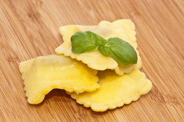Blank Raviolis on wooden background