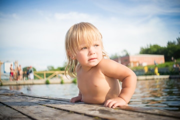 Adorable baby climb to pier from water