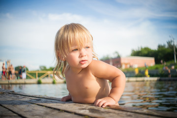 Adorable baby climb to pier from water