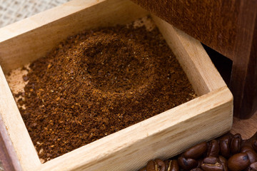 Freshly ground coffee in grinder box