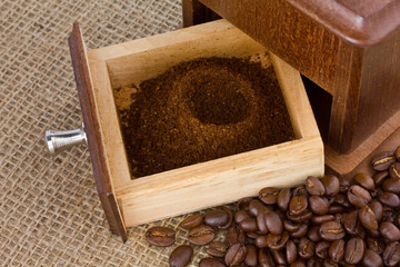 Freshly ground coffee with wooden grinder