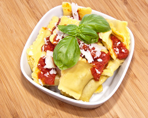 Bowl with Raviolis on wooden background