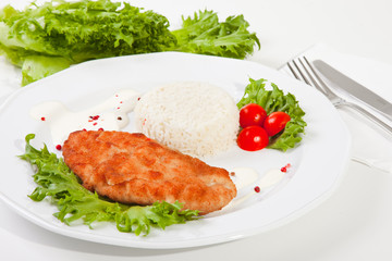 meat with mixed leaf salad an rice on white
