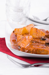 Fish with potatoes and black olives.