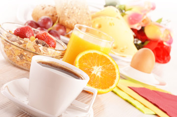 Breakfast on the table. Coffee, orange juice, rolls, muesli.