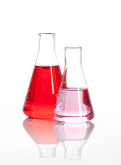 Two Erlenmeyer glass flasks with a red liquid