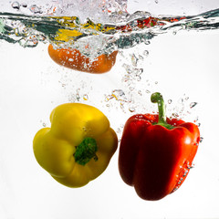 Red and Yellow Pepper Dropped into Water