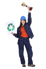 Female builder holding trophy and recycling logo