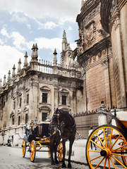 Naklejka na ściany i meble Cathedral of Seville with carrige horse, Spain