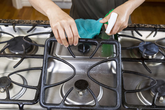 Spraying down Stove Top Range for Cleaning