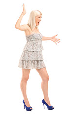 Full length portrait of a nervous blond female shouting