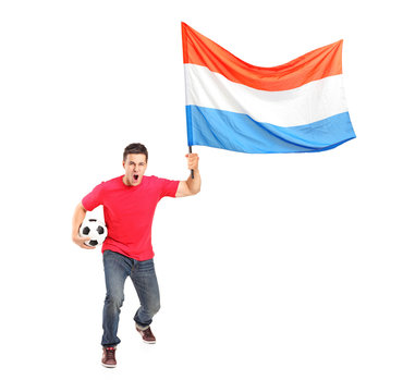 Male football fan holding a Netheralnds flag