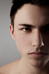 Obraz premium Handsome face of a young man on grey