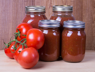 Tomato sauce in jars and tomatoes