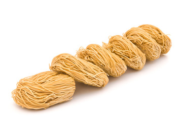 raw noodles line up on white