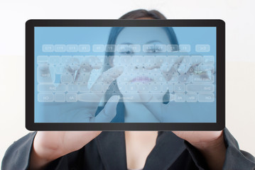 Business lady pushing keyboard on the tablet screen.