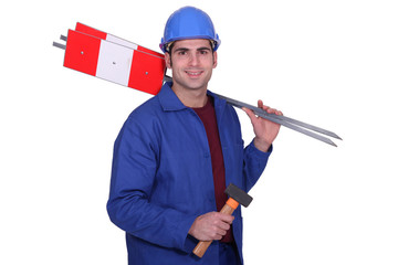 Road worker holding signs and hammer