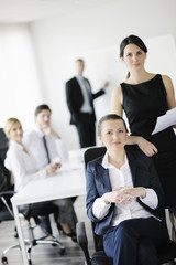 business woman with her staff in background