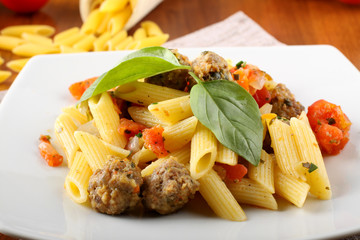 Pasta with meatballs, tomato and basil