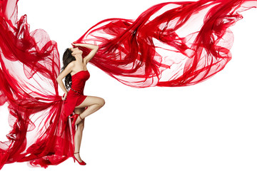 Beautiful woman dancing in red dress flying on a wind flow over