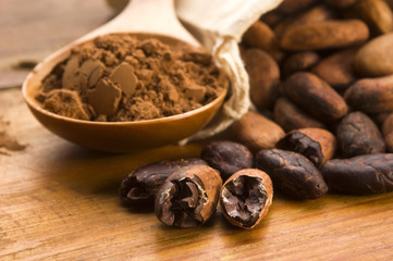 Cocoa (cacao) beans on natural wooden table
