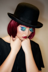 Pretty young female with auburn hair and bowler hat