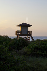 Fototapeta na wymiar Lifeguard tower on florida beach at sunrise