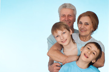 Happy Caucasian grandparents with grandchildren fooled