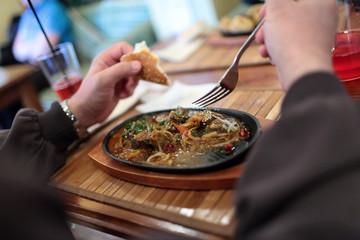 Man eating stewed kidneys of lamb