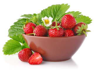ripe strawberry in tureen with green leaves and flower