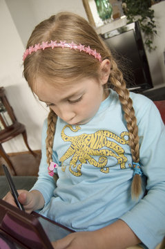 Little girl playing with electronic gadget