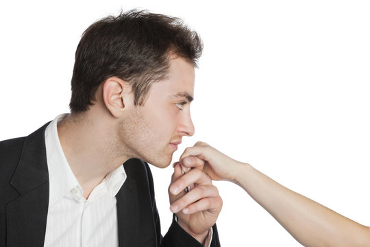 Young professional kissing female hand