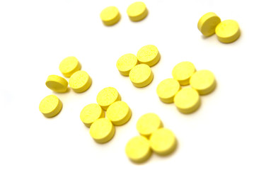 Yellow pills on white