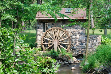 A Rustic Waterwheel with Foliage